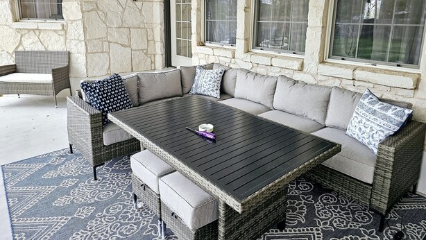 A stone-walled outdoor seating area with a sofa, chairs, and a table. - PENION HOME! HOT TUB FOR 6/7 - SPACIOUS YARD FOR KIDS! (Austin)