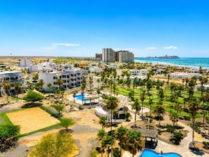 A resort with multiple buildings, a pool area, and a beach view. - Casa Blanca D703 Pet Friendly Ocean View Condo (Puerto Peñasco)