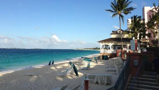 A beach with a building that has a covered area and a staircase leading to it. - Private Pool & Garden - Tranquil Retreat (Paradise Island)