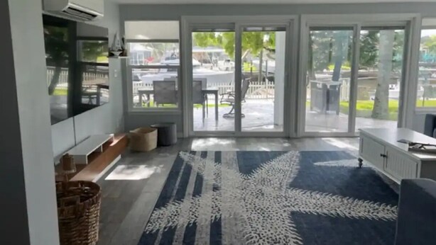 A modern kitchen with a built-in oven, a large window, and a view of the outdoor patio area. - Summer Fun! New Port Richey Fl

 (New Port Richey)