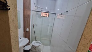 A small bathroom with a toilet, bidet, and a shower stall. - MATEUS ALVES DA SILVA (São João da Paraúna)