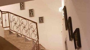 A staircase with ornate metal railings and dark marble steps.