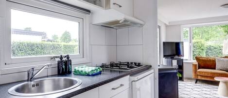 Fridge, coffee/tea maker, high chair, cookware/dishes/utensils