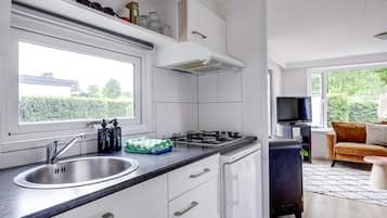 Fridge, coffee/tea maker, high chair, cookware/dishes/utensils
