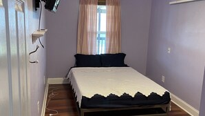 A bedroom with a bed, a ceiling fan, a television mounted on the wall, and a window with curtains. - Waterfront Bayou living only 30 minutes from New Orleans, Dock Fishing (Lafitte)