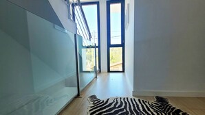 A modern interior with a glass wall, a zebra-patterned rug, and large windows. - Villa with beautiful swimming pool  (CT)