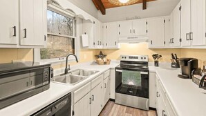 A modern kitchen with white cabinets, a built-in oven, a microwave, and a coffee maker. - 4BR Chalet-A/C-New deck! Calm Creek-Quiet-2 Kings (Beech Mountain)