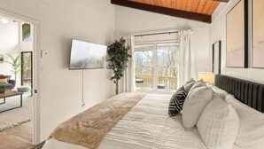 A bedroom with a bed, a TV, a window, and a plant. - 4BR Chalet-A/C-New deck! Calm Creek-Quiet-2 Kings (Beech Mountain)