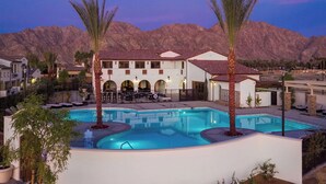 A resort with a swimming pool, palm trees, and a mountainous backdrop. - PGA West-Catching Sunsets-3bd 2ba in Signature (La Quinta)