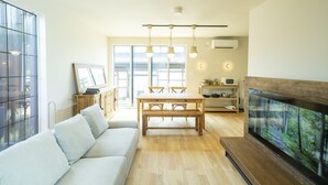 A modern living room with a sofa, dining table, and TV. - raw_ (Hakuba)