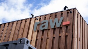 A building with a wooden facade and the word "raw" displayed prominently.