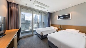 A hotel room with two beds, a desk, a chair, a TV, and a large window with a city view. - Marysol by haeundae beach (Busan)