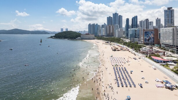A beach with a city skyline in the background. - Marysol by haeundae beach (Busan)