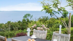 A dining table with chairs and a view of the sea. - Gorgeous home in ølsted with kitchen (Ølsted)