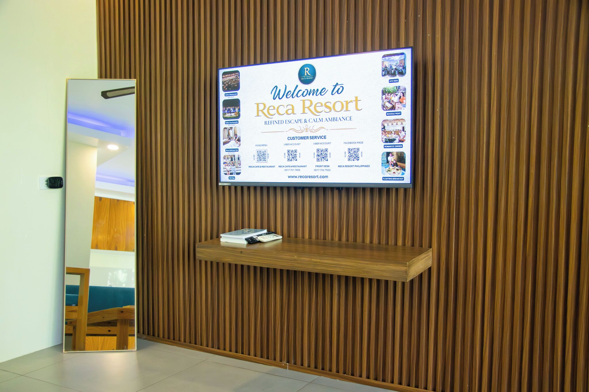 A reception area with a welcome sign, a mirror, and a wooden shelf.