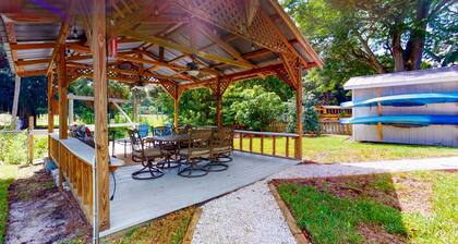 Riverfront dog-friendly cottages with kayaks, dock, patio, grill, & water views