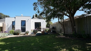 A two-story house with a front yard, a wooden fence, and a tree. - Chevignon country charm in the heart of town (Queenscliff)