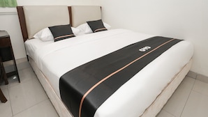 Una cama bien hecha con colcha y almohada en blanco y negro.