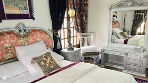 A bedroom with a large bed, a dresser, a mirror, and a nightstand. - One bedroom apartment city views local to Airport (El Nozha)