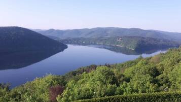A lake surrounded by forested hills.