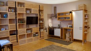 A compact kitchen with wooden cabinetry, a built-in oven, a sink, and a refrigerator. - Chalet 'Feinis' with Private Terrace, Garden, and Wi-Fi (Waasen)