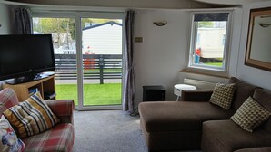 A living room with a television, a sofa, a couch, and a small table. - The Shak, Tarbolton, Middlemuir Holiday Park (Tarbolton  Mauchline)