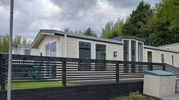 A mobile home with a fenced yard, a small shed, and a grassy area. - The Shak, Tarbolton, Middlemuir Holiday Park (Tarbolton  Mauchline)