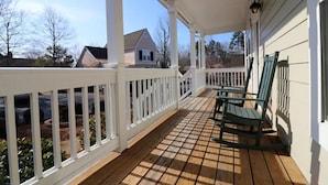 A wooden deck with white railings and a covered porch area. - Spacious 3BR Cottage - Family Friendly Resort - Close to Theme Parks (Williamsburg)
