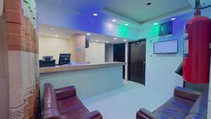 A reception area with a counter, computers, and seating. - Hotel The Sylhet Int. (Dhaka)