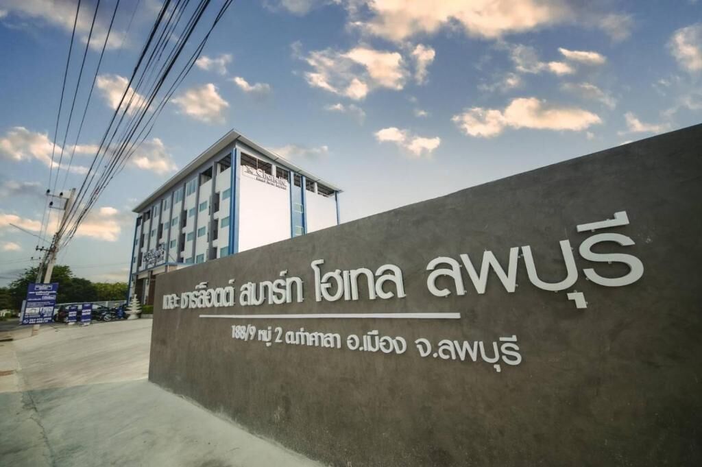 A building with a sign in Thai script, indicating it is a hotel.