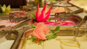 A buffet with various food items and garnishes.