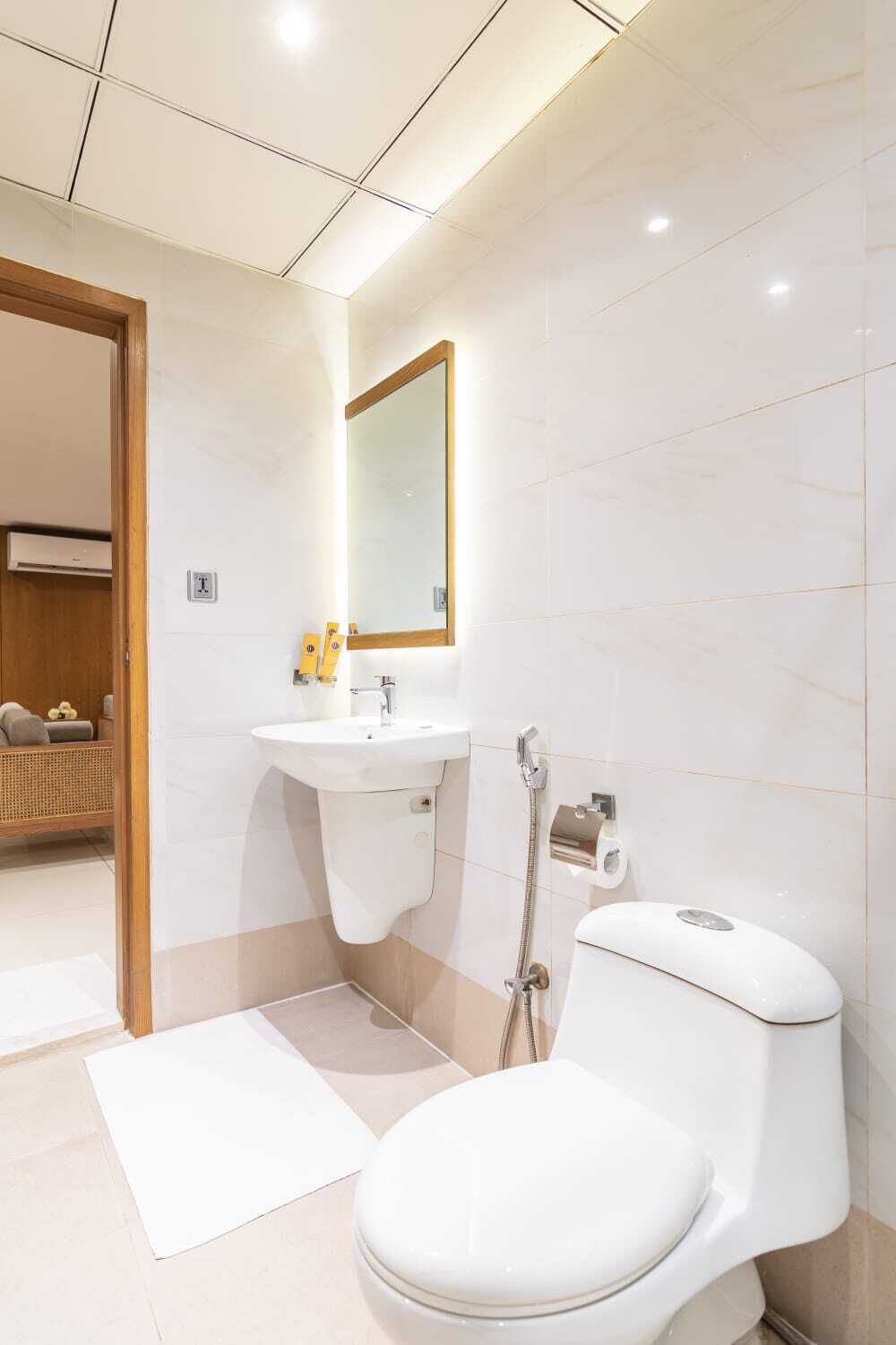 A modern bathroom with a toilet, sink, and shower.