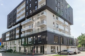 A multi-story building with balconies, large windows, and a modern architectural design.