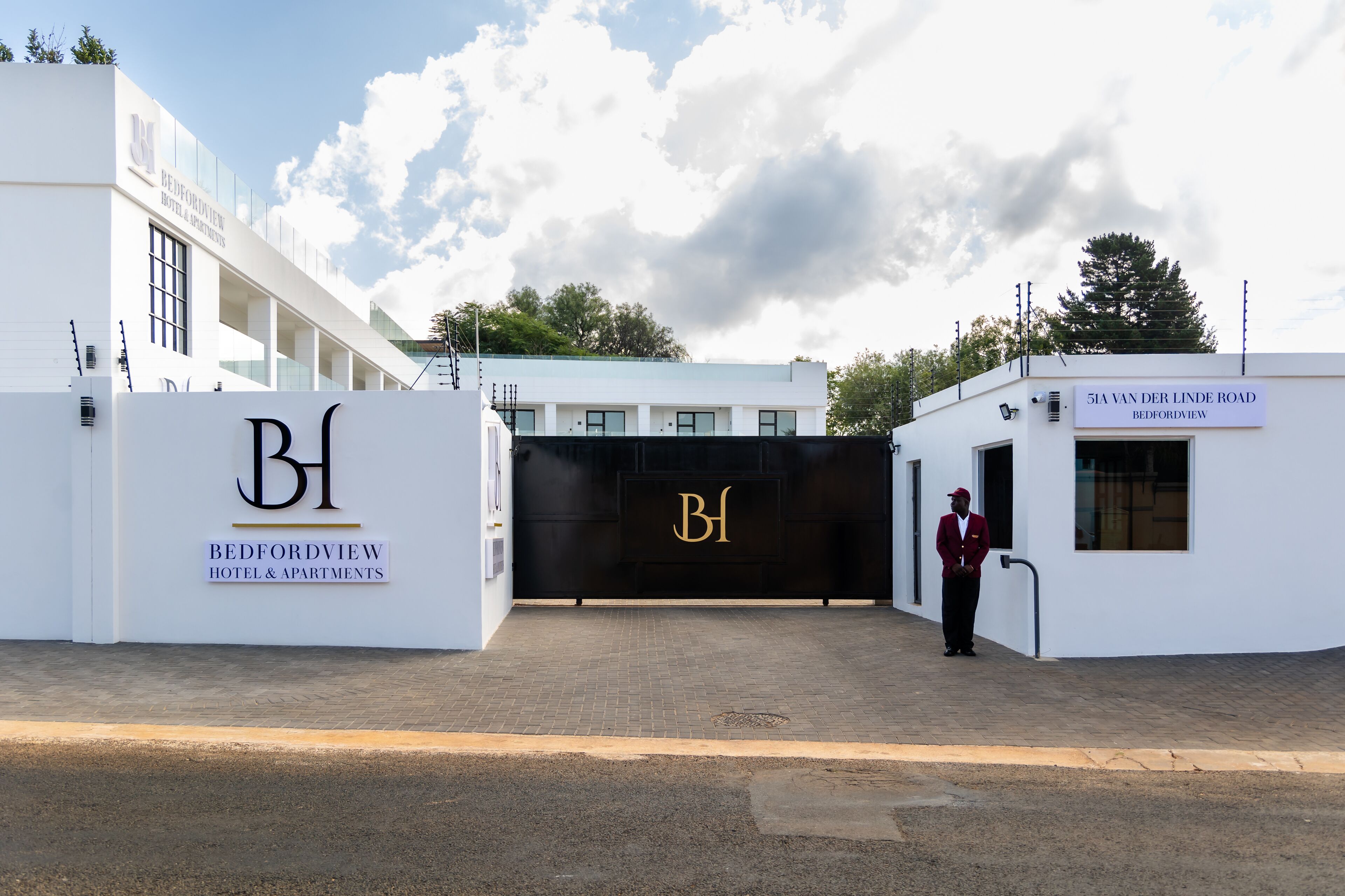 The entrance to Bedfordview Hotel & Apartments with a clear view of the entrance gate and signage.