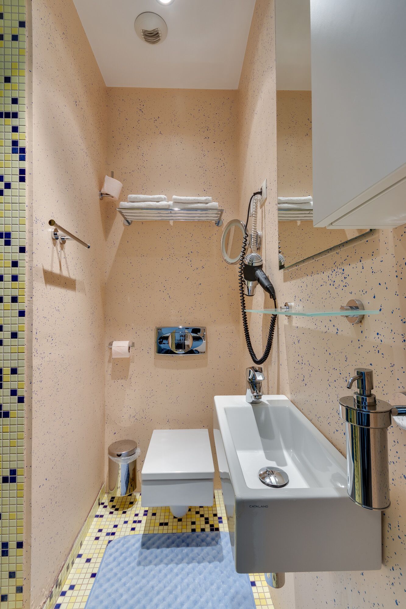 A modern bathroom with a bathtub, sink, toilet, and a mirror.
