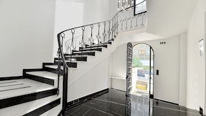 A staircase with black and white steps and a black railing. - Athenian Gem (Athens)