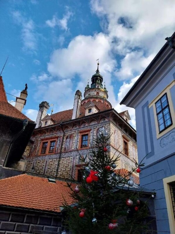 A historic building with a prominent tower and ornate facade, surrounded by other buildings. - Penzion Albatros (Cesky Krumlov)