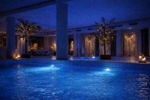 An indoor swimming pool with lights, palm trees, and a modern interior. - Best Western Hotel Palace Lucera (Lucera)
