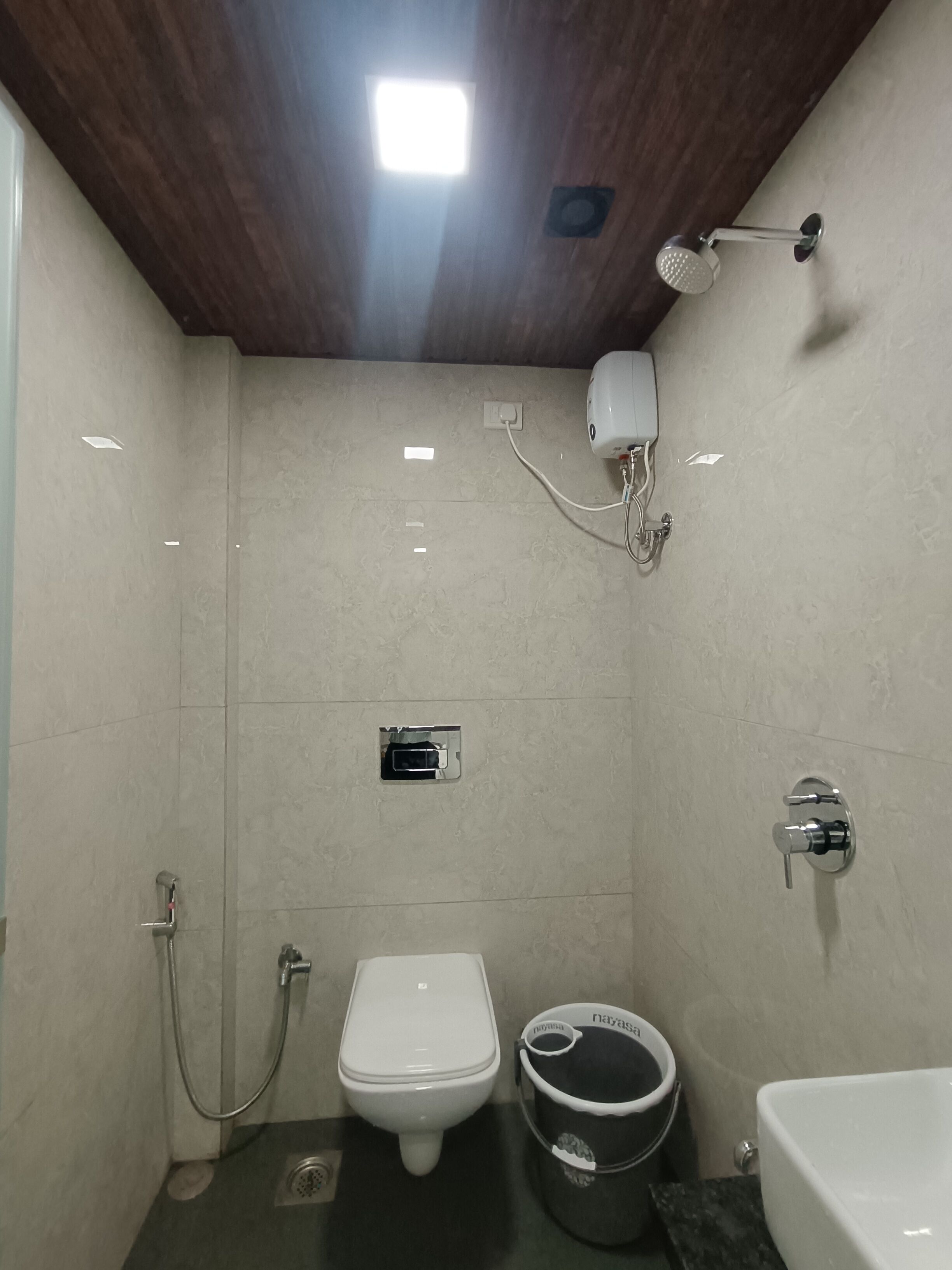 A small, compact bathroom with a toilet, bidet, and sink.