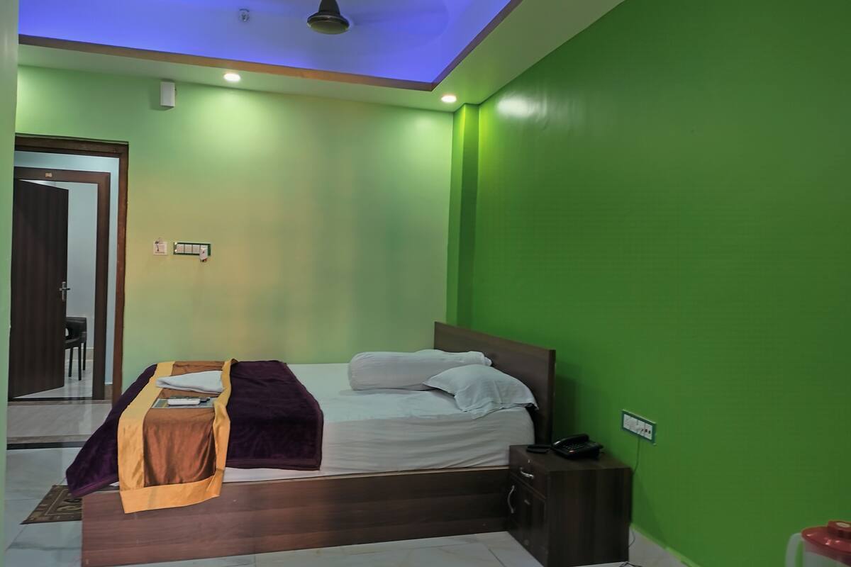 A bedroom with a bed, bedside table, and a nightstand.