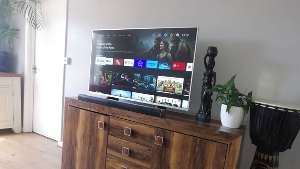 A flat-screen TV on a wooden cabinet displaying a streaming service interface with various apps. - Seaview/downs National Park & Free Parking (Brighton)
