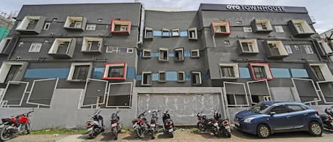 A building with a unique architectural design, featuring multiple balconies and windows.