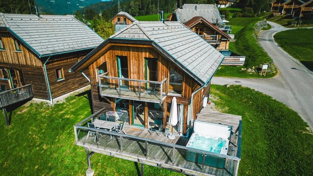 A wooden chalet with a glass balcony and a hot tub. - 022 W2 in St Georgen am Kreischberg (Sankt Georgen am Kreischberg)