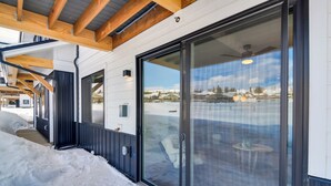A modern building with a wooden ceiling, large sliding glass doors, and a view of a snowy landscape. - 2 Mi to Fraser Tubing Hill: Condo w/ Fireplace! (Fraser)