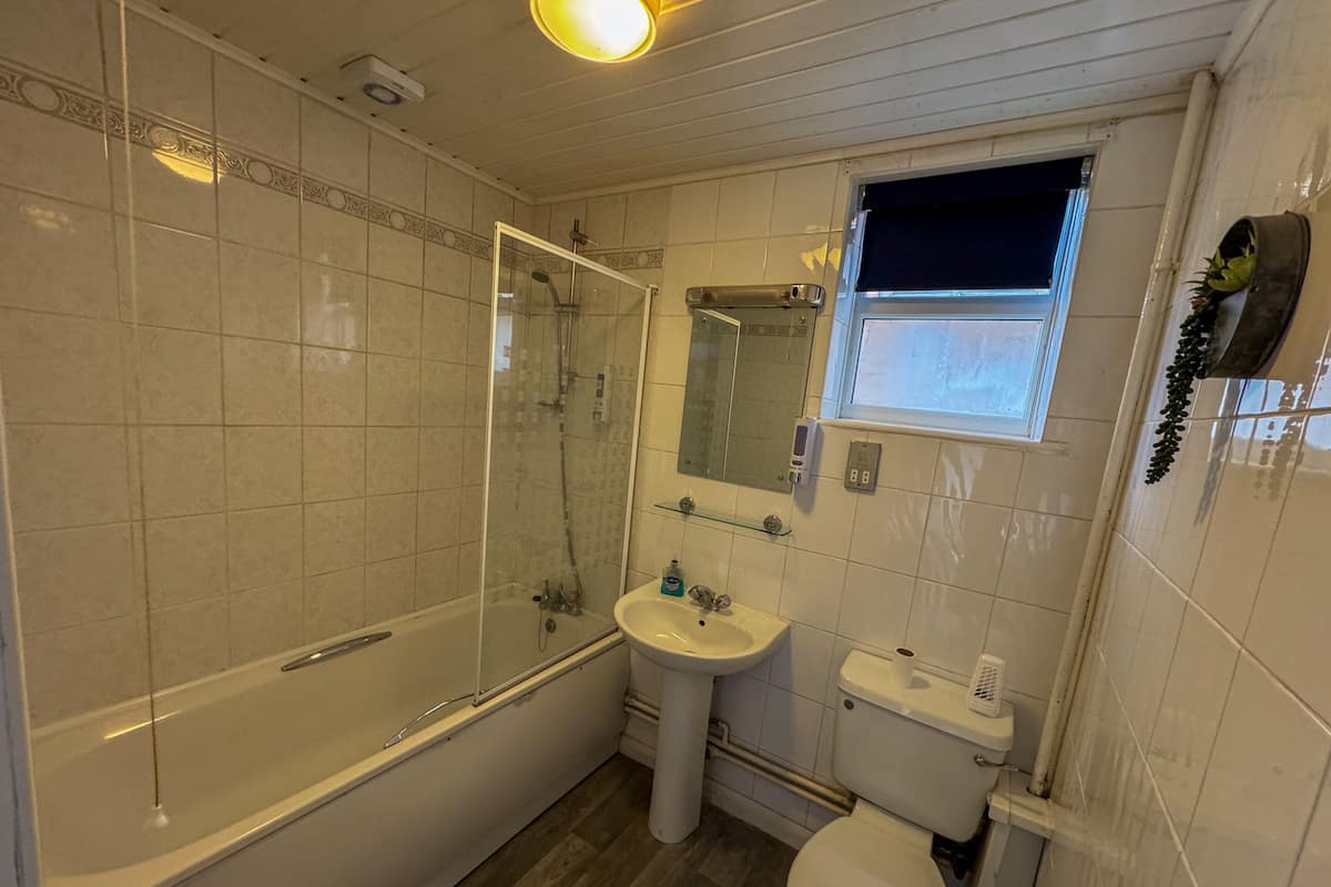 A bathroom with a bathtub, sink, and toilet.