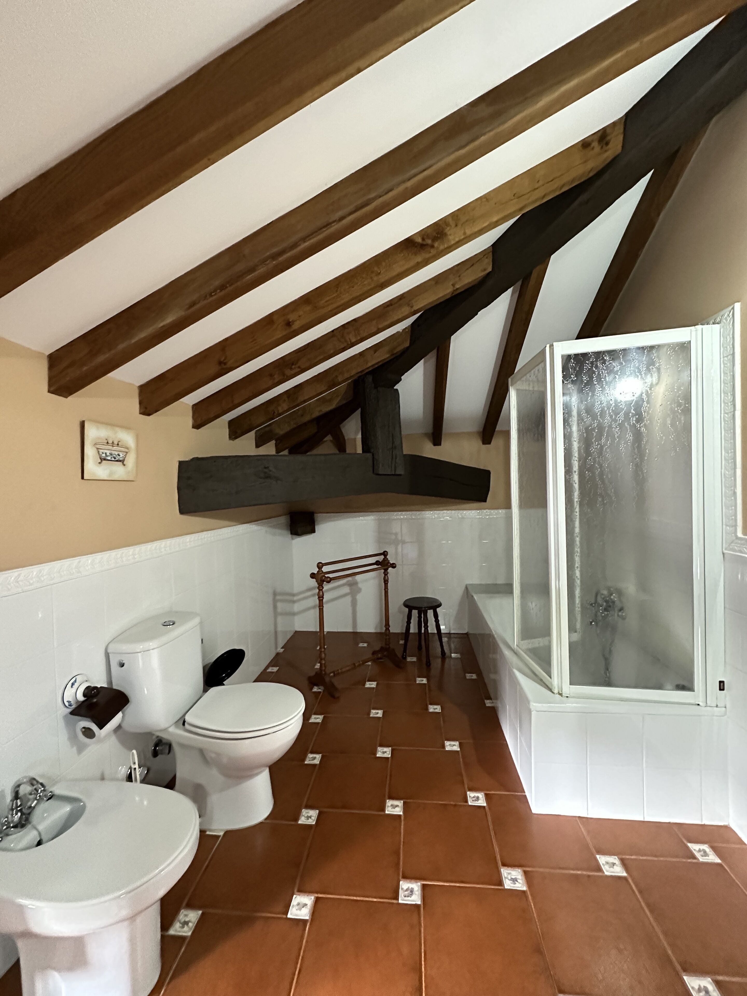 Un baño con inodoro, lavamanos y ducha.