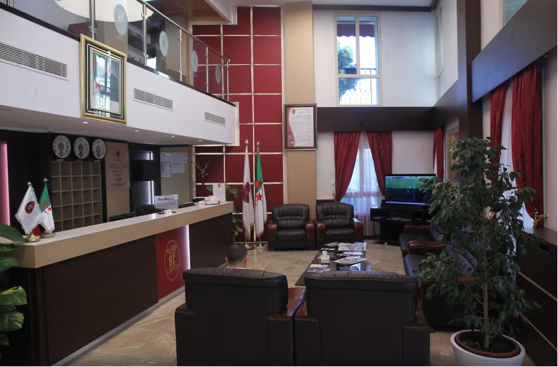 A reception area with a counter, flags, and seating.