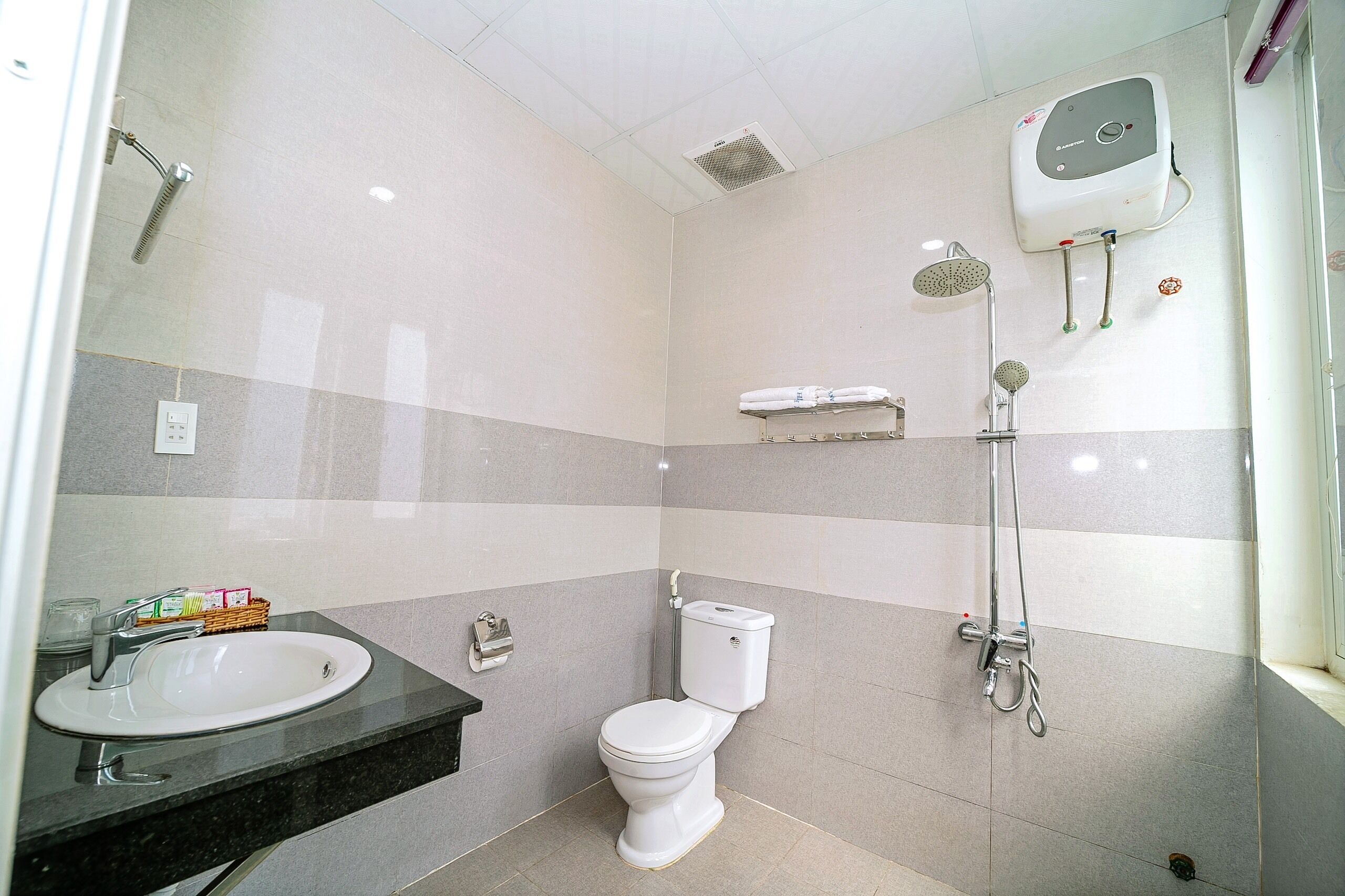 A modern bathroom with a toilet, sink, and shower.