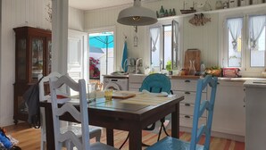 A kitchen with a dining table, chairs, and a washing machine.