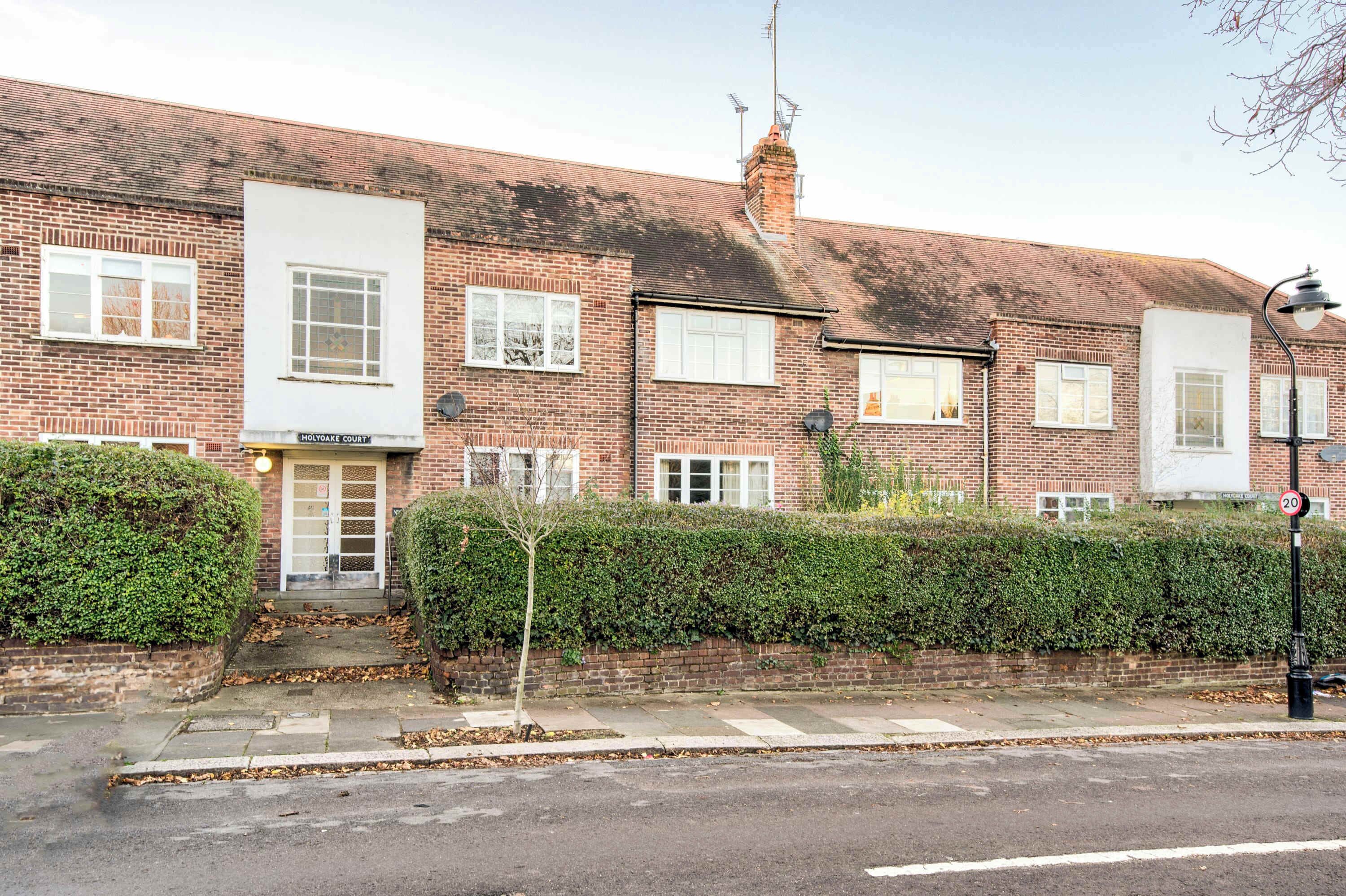 A row of terraced houses with a sign for "HOLYOKE COURT" on the front.